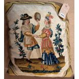 An early George III needlework cushion, woven as a dancing couple, he holding a tambourine,