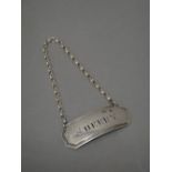 A Scottish provincial silver decanter label, of cut cornered curved rectangular form,