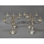 A set of four silver two light table candelabra,