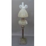 A Victorian and later, silver plated and glass oil lamp, the base of Corinthian column form,
