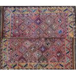 An Uzbek Julkhyrs carpet, cut, the polychrome field with diamonds, a saffron leaf border,