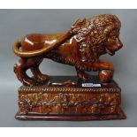 A pair of Staffordshire treacle glaze Medici lions, 19th century,