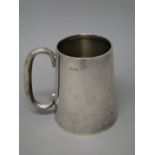 A silver mug, of tapering cylindrical form, with a 'C' shaped handle, presentation inscribed,