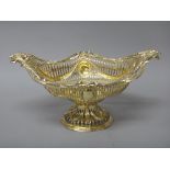 A silver gilt basket, of oval form, cast and pierced with swags and oval cartouches,