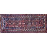 A Kurdish Afshar Kelleh, Persian, the indigo field with a madder panel with single medallions,
