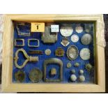 A small glazed frame containing metal detector finds, including; coins, buckles, buttons and sundry,