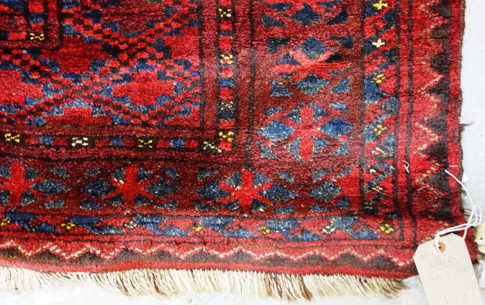 An Afghan Esari carpet, the dark madder field with three columns of six bold guls, - Image 6 of 12