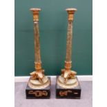 A pair of Empire style parcel gilt faux marble torchère stands, each with turned column,