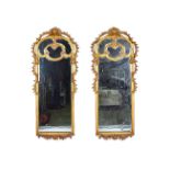 A pair of large 19th century gilt framed arch top bevelled glass marginal wall mirrors,