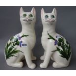 A pair of Griselda Hill pottery `Wemyss ware' cats, late 20th century, decorated with thistles,