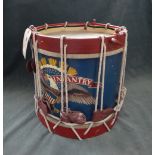 A wooden and rope bound bandsman's parade bass drum, painted red,