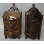 A near pair of French late 19th century walnut candle/salt boxes, with carved floral decoration,