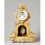 A French giltmetal mantel clock circa 1870 The case surmounted by a floral spray above the glazed