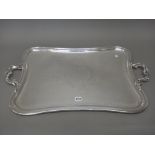 A plated shaped rectangular twin handled tray, with a decorated border,