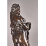 A Victorian style patinated bronze, cast as a semi-nude classical female figure, early 20th century,