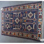 A Shirvan rug, Caucasian, the indigo field with central ivory medallion, ivory angular brackets,
