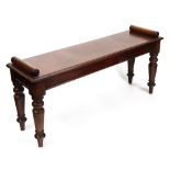 An early Victorian mahogany hall bench, the moulded rectangular seat with roll ends,