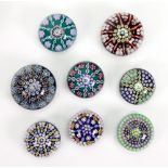 A collection of eleven modern Perthshire millefiori and other glass paperweights including limited
