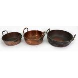 A collection of three Victorian copper and brass preserve pans, each with twin raised side handles,