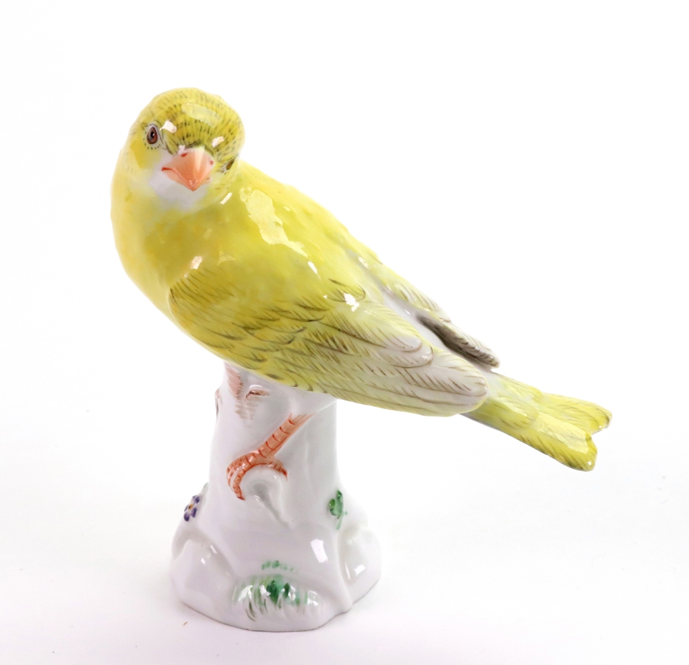 A Meissen model of a yellow bunting, 20th century, modelled perched on a tree stump,