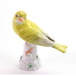 A Meissen model of a yellow bunting, 20th century, modelled perched on a tree stump,