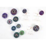 A collection of eleven modern Perthshire millefiori and other glass paperweights including limited