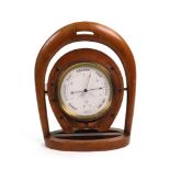 An oak cased aneroid barometer, circa 1900, with brass bezel,