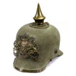 A Pickelhaube, the applied gilt metal crest with motto 'In Treue fest'.