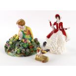 A Crown Staffordshire porcelain figure modelled as a young girl kneeling picking flowers from a