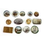 A collection of thirteen old glass paperweights, of varying shapes, mostly circular,