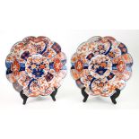 A pair of Japanese Imari porcelain chargers with scalloped rims and foliate decoration, 30cms diam.