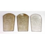 A set of three Art Deco frosted glass panels, moulded with a dragon and flaming panels,