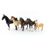 A collection of five Beswick pottery figures of horses, including Exmoor,