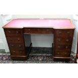 A Victorian mahogany inverted breakfront kneehole desk, circa 1860, with later inset top,