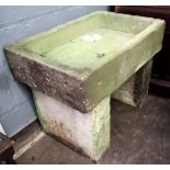 A rectangular stone sink, 19th century, on rectangular end standards, 78cm wide, 52cm deep,