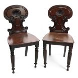 A pair of Regency mahogany hall chairs,