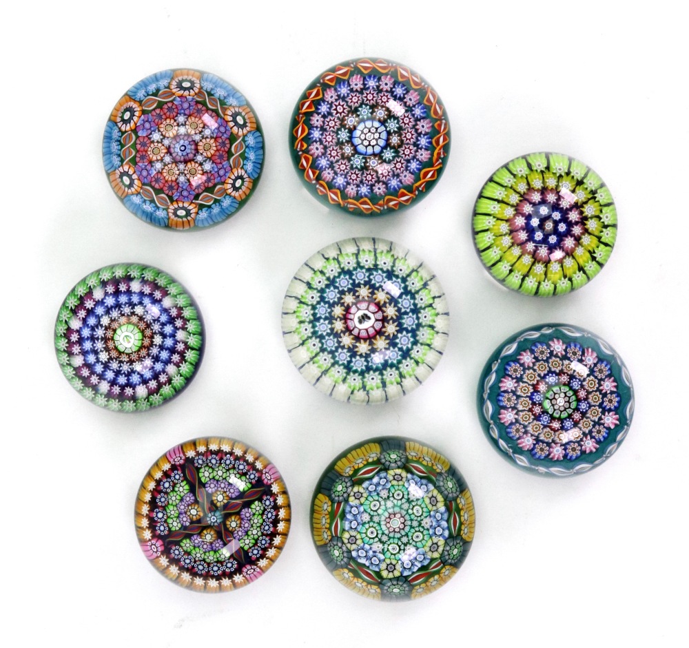 A collection of eleven modern Perthshire millefiori and other glass paperweights including limited