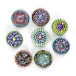 A collection of eleven modern Perthshire millefiori and other glass paperweights including limited