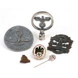 A collection of six Nazi badges including: a DDAC enamel uniform badge; a DDAC 1934 stick pin;