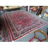 A Sarough carpet, Persian, the madder field with a large faceted medallion, indigo spandrels,