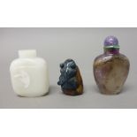 A Chinese amethyst quartz snuff bottle, late 19th/20th century, carved with lotus flowers, 5.5cm.