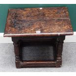 A mid-17th oak joint stool of large proportions, the twin plank top over lunette carved frieze,