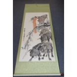 A Chinese scroll painting of a girl with water buffaloes, watercolour on paper, signed, 132cm.