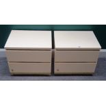 A pair of 20th century cream lacquer two drawer bedside tables, on gold plinth bases,