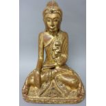 A Burmese giltwood Buddha, late 19th/ 20th century, seated in dhyanasana with hands in bhumisparsa,