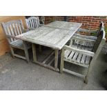 A 20th century rectangular teak garden table and four chairs, 180cm wide, (5).