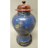 A Chinese blue ground baluster vase, gilt with dragons and phoenix amongst cloud scrolls, 35cm.