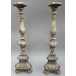A pair of Italian grey painted carved wooden altar candlesticks, each of turned form,