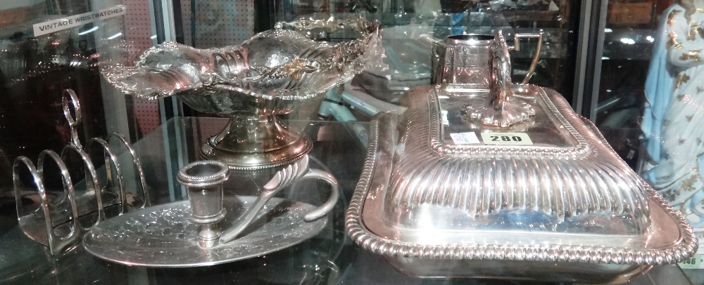 Silver plated wares, including; a fruit bowl of wavy form, jug, toast rack, chamber stick,
