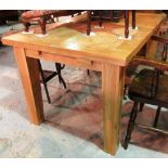 A 20th century oak extending dining table, on square tapering block supports,
